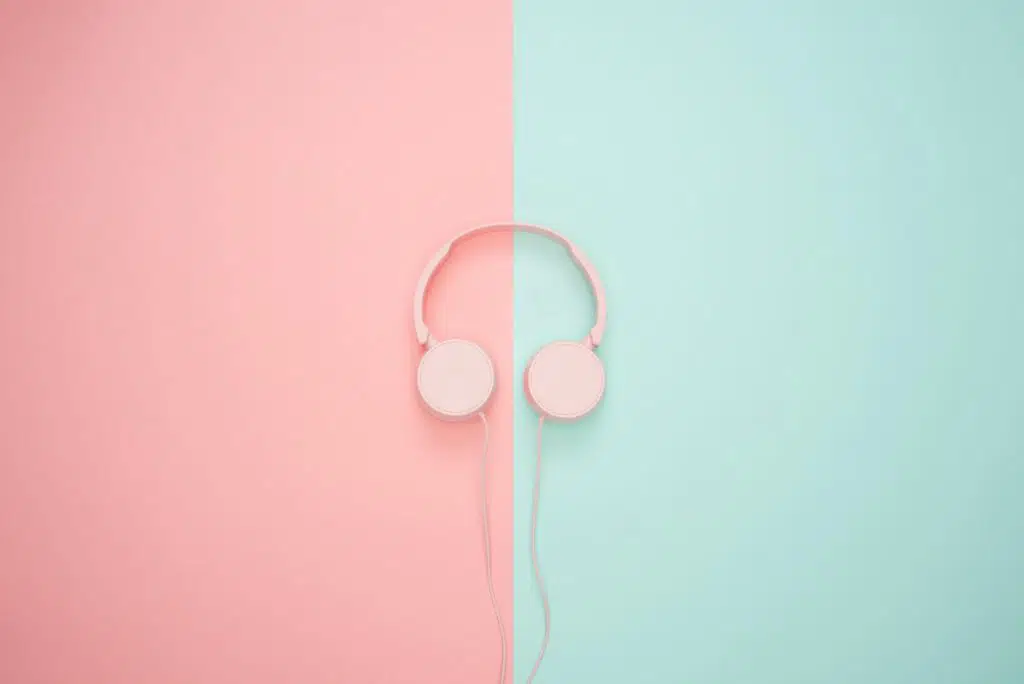Pink headphones on a pastel background